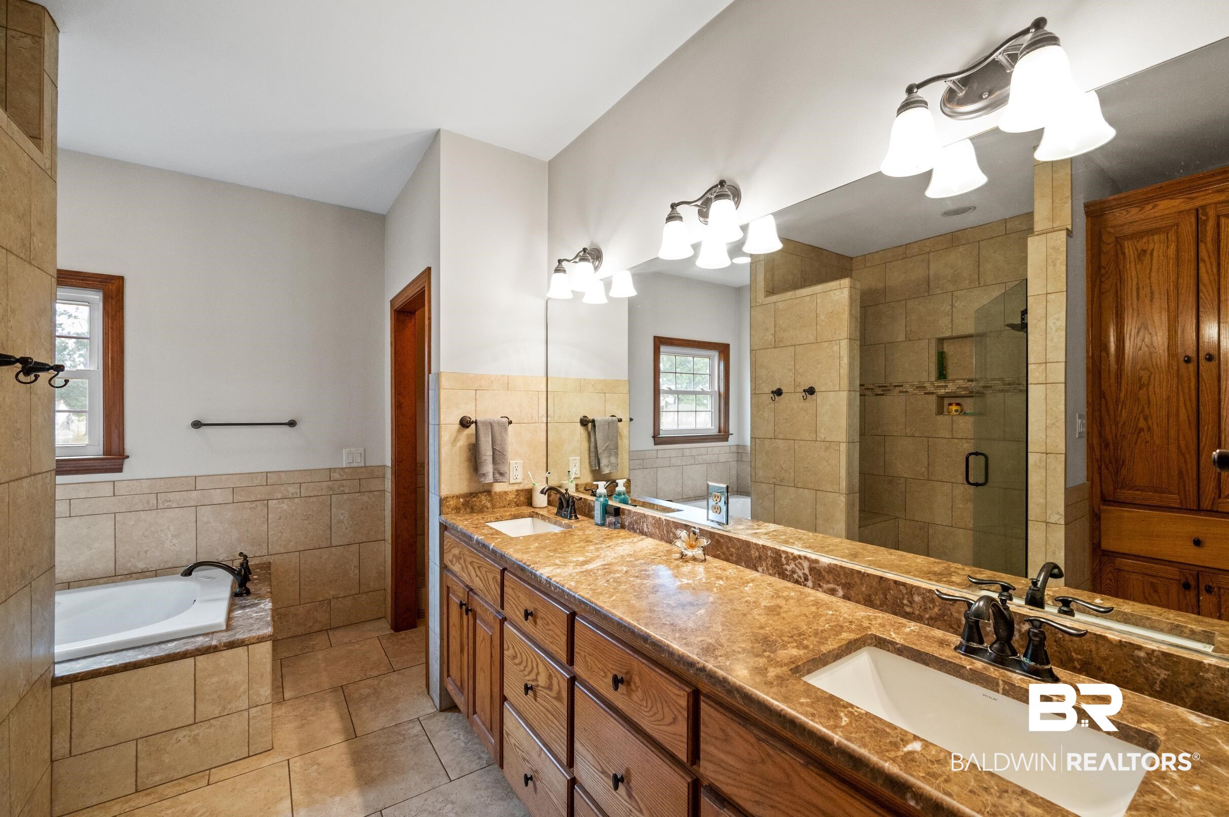 13871 Underwood Road Summerdale, AL 36580 - Photo 11 of 33 Bathroom featuring tile floors, double vanity, natural light, tiled shower and jetted bathtub