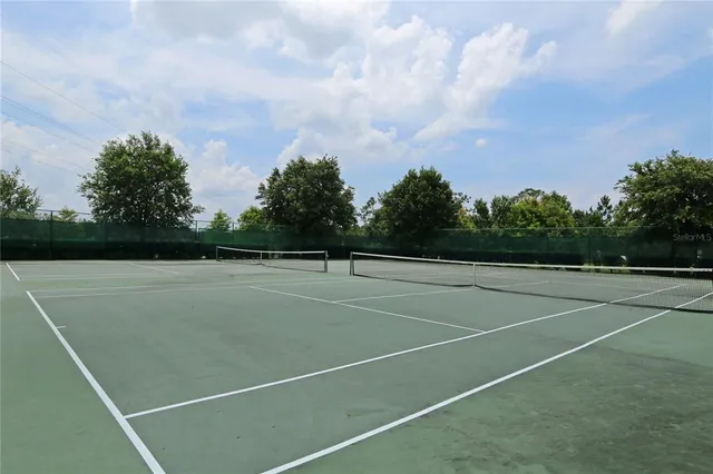 an aerial view of a house with a yard and lake view