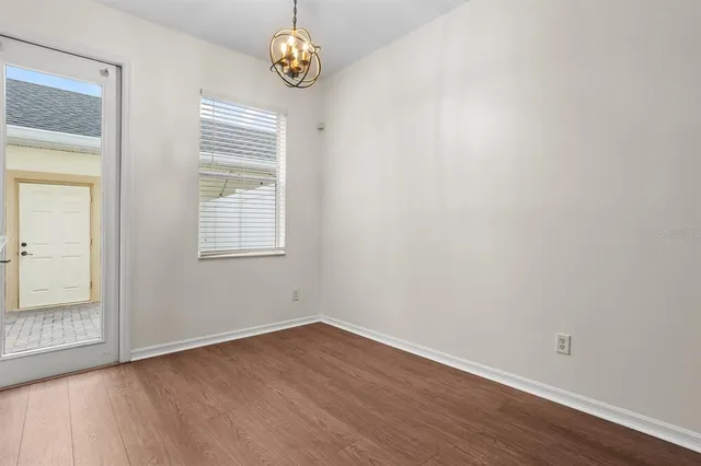 a kitchen with a sink cabinets and wooden floor