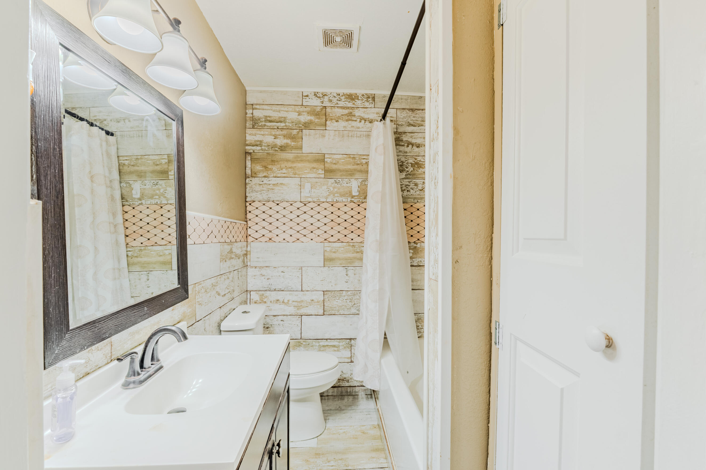 112 West 34th Street, Unit 1 Riviera Beach, FL 33404 - Photo 12 of 27 a bathroom with a sink and a mirror
