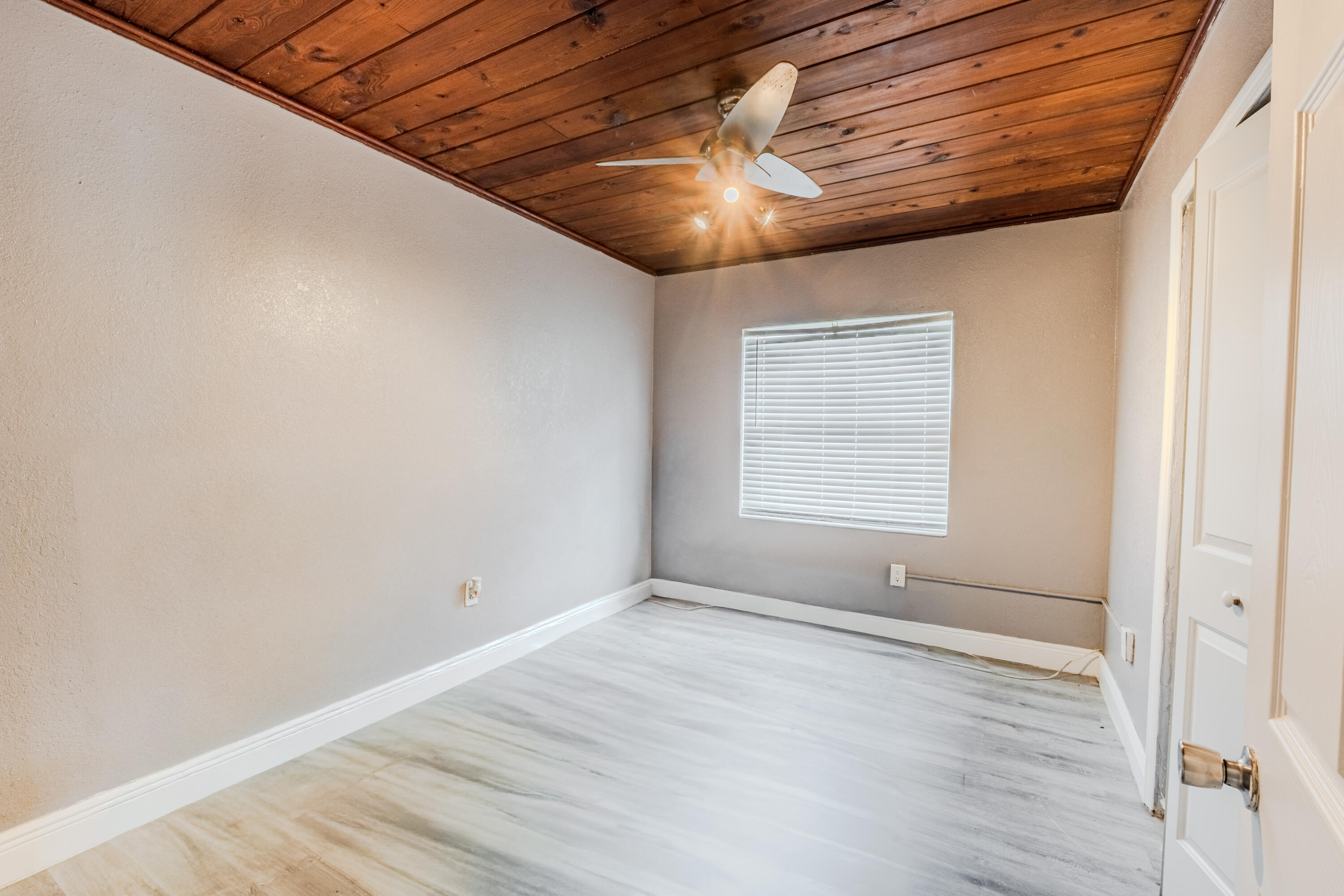 112 West 34th Street, Unit 1 Riviera Beach, FL 33404 - Photo 14 of 27 a view of an empty room with wooden floor and a window
