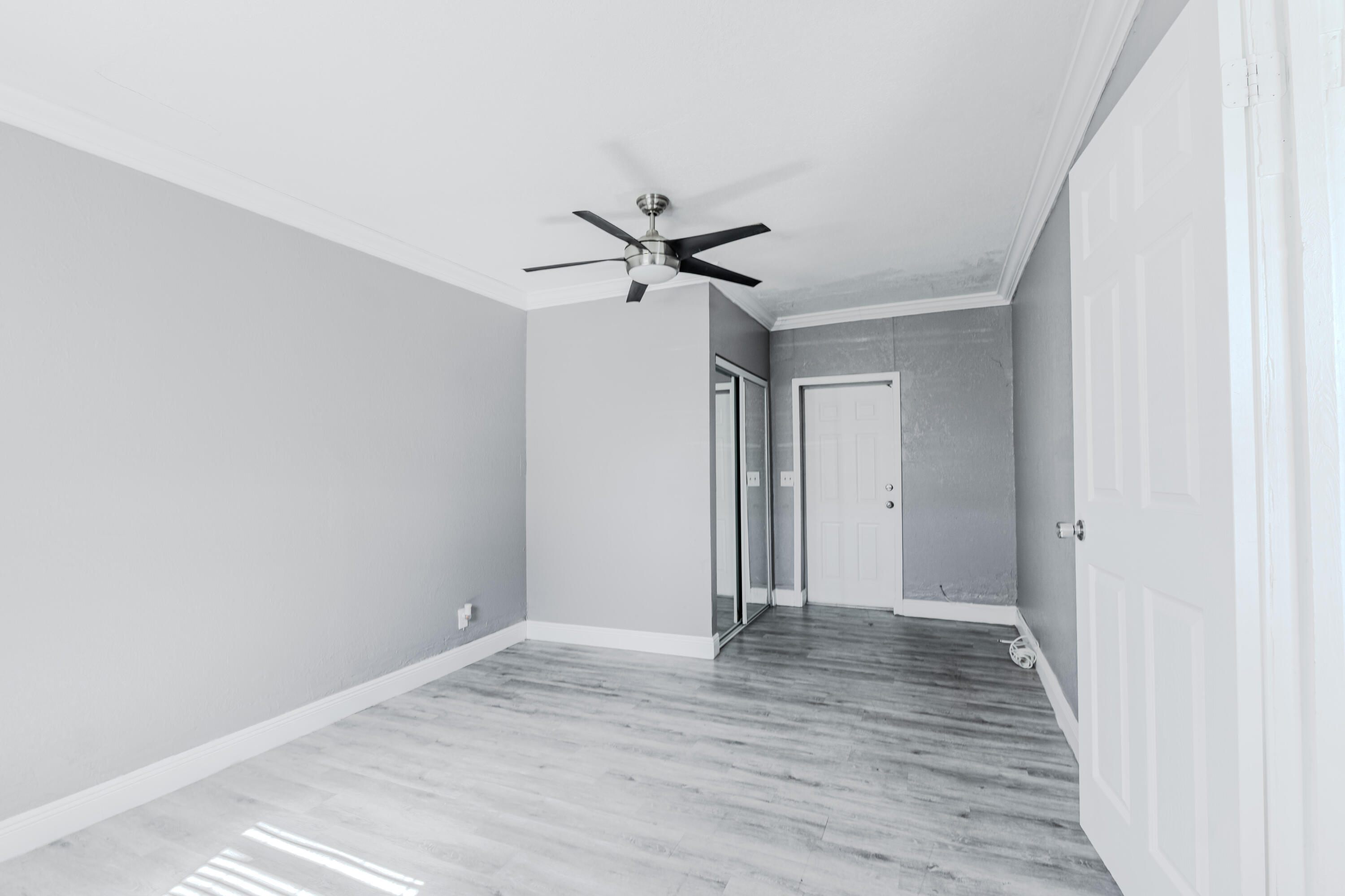 112 West 34th Street, Unit 1 Riviera Beach, FL 33404 - Photo 16 of 27 a view of an empty room with wooden floor