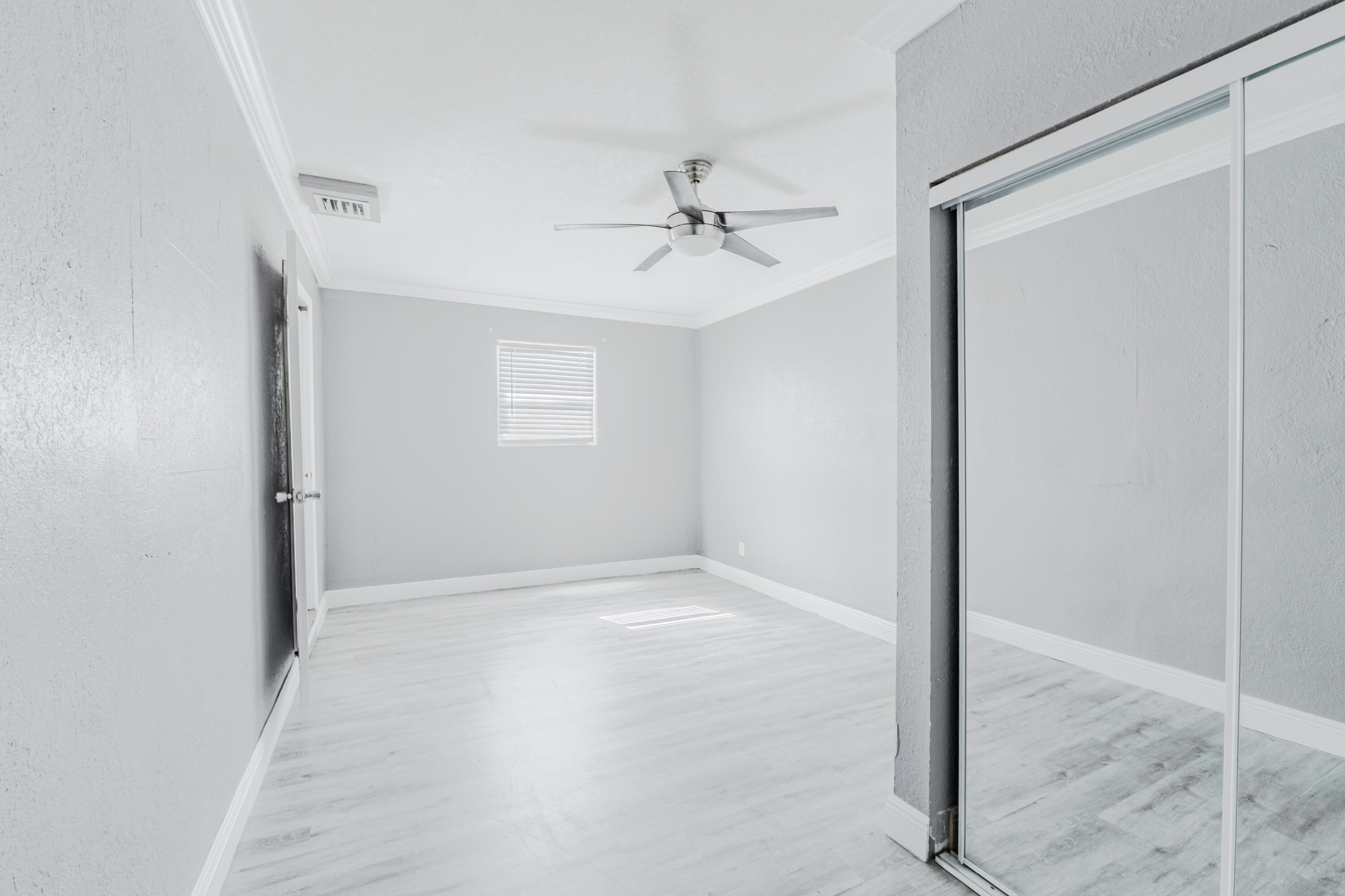 112 West 34th Street, Unit 1 Riviera Beach, FL 33404 - Photo 17 of 27 an empty room with a ceiling fan and a window