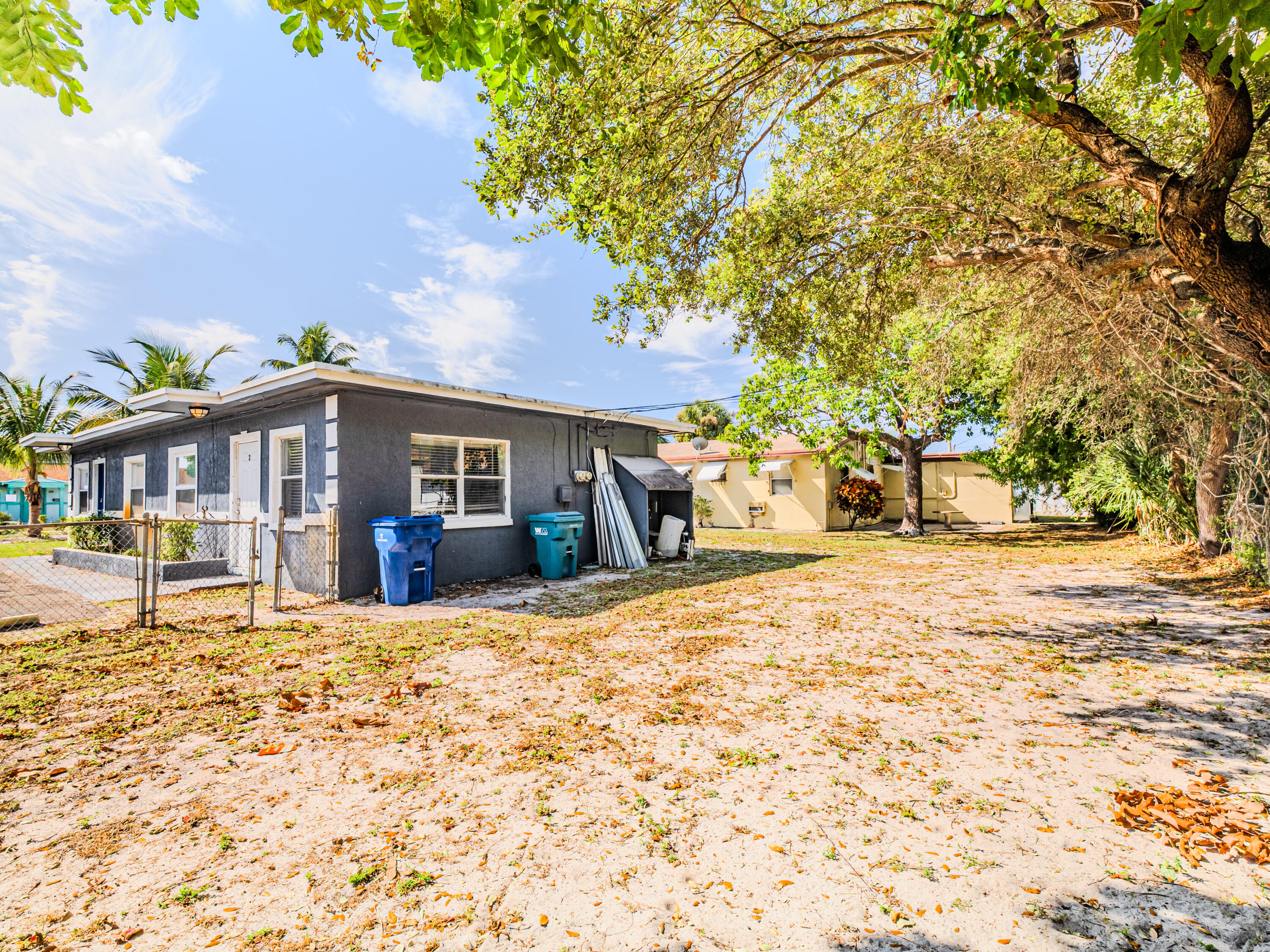112 West 34th Street, Unit 1 Riviera Beach, FL 33404 - Photo 3 of 27 a front view of a house with a yard and fountain