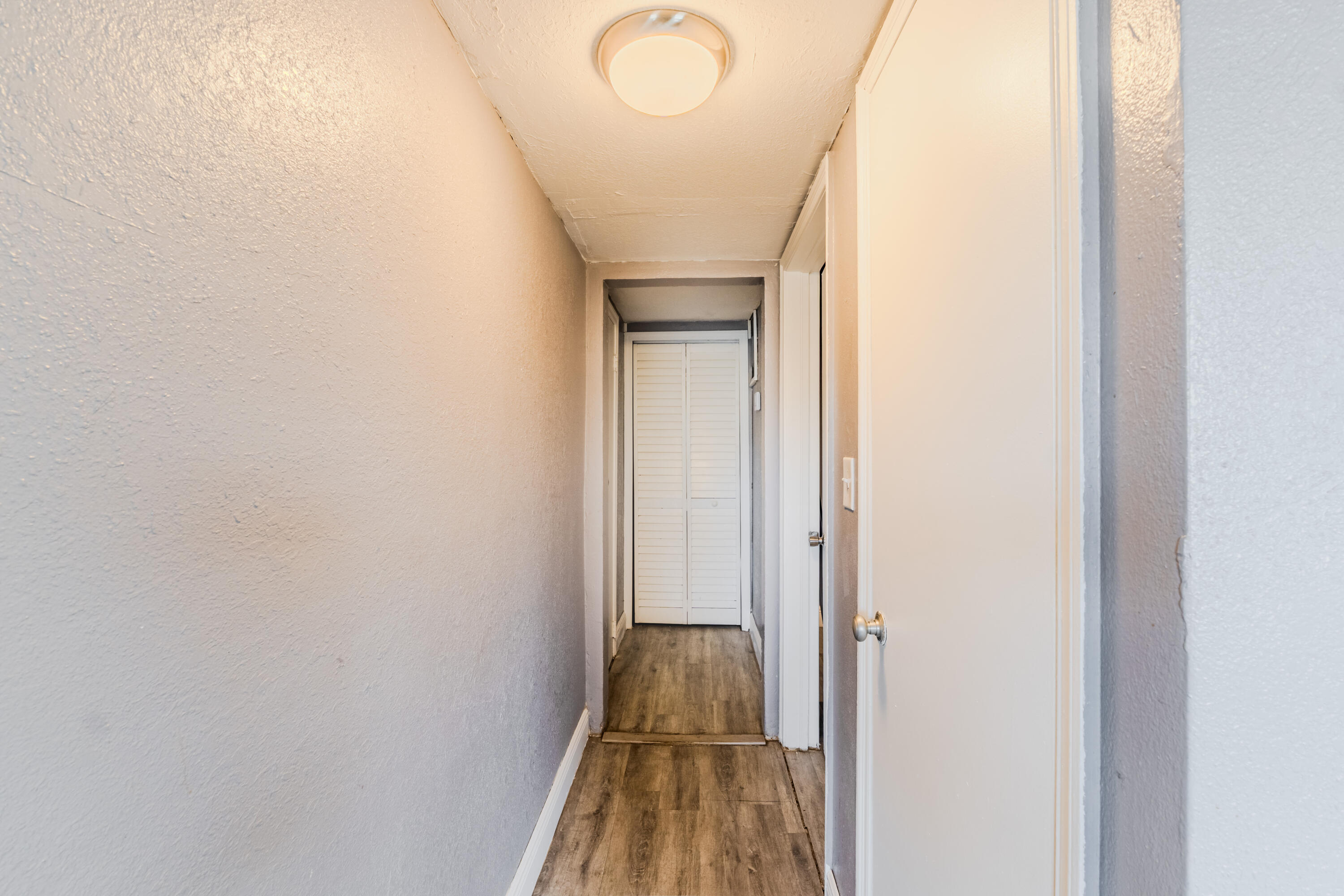 112 West 34th Street, Unit 1 Riviera Beach, FL 33404 - Photo 10 of 27 a view of a livingroom with wooden floor and a staircase