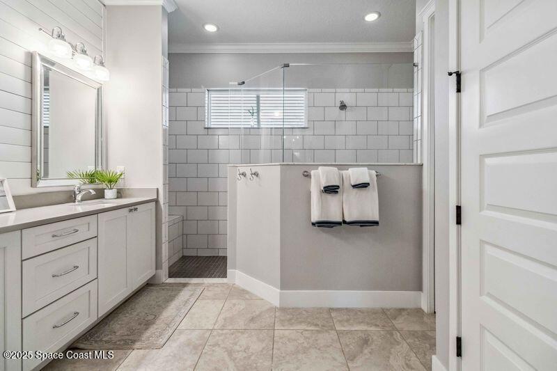 4620 Highway 1 Grant, FL 32949 - Photo 12 of 65 a bathroom with a double vanity sink and mirror