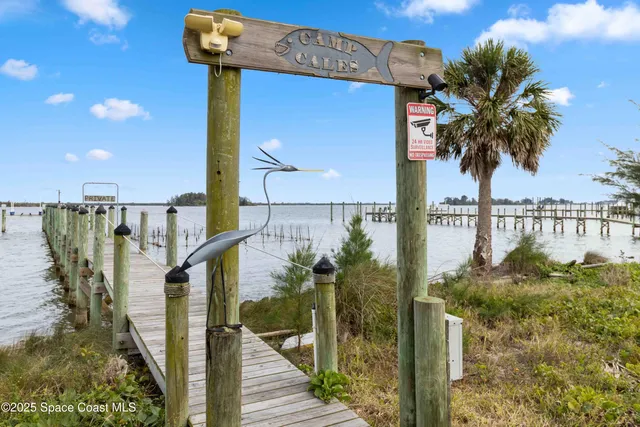 an aerial view of a house with outdoor space and seating area
