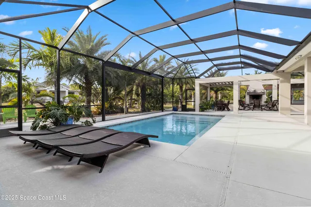a dining room with wooden floor a glass table and chairs
