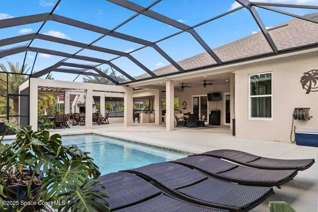 a view of a patio with table and chairs under an umbrella