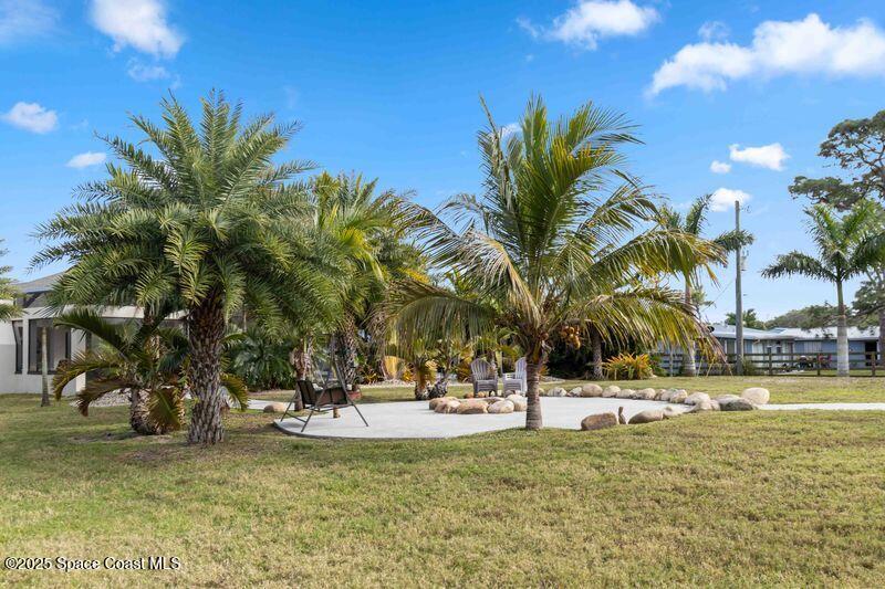 4620 Highway 1 Grant, FL 32949 - Photo 37 of 65 a view of a swimming pool with a lawn chairs and palm tree