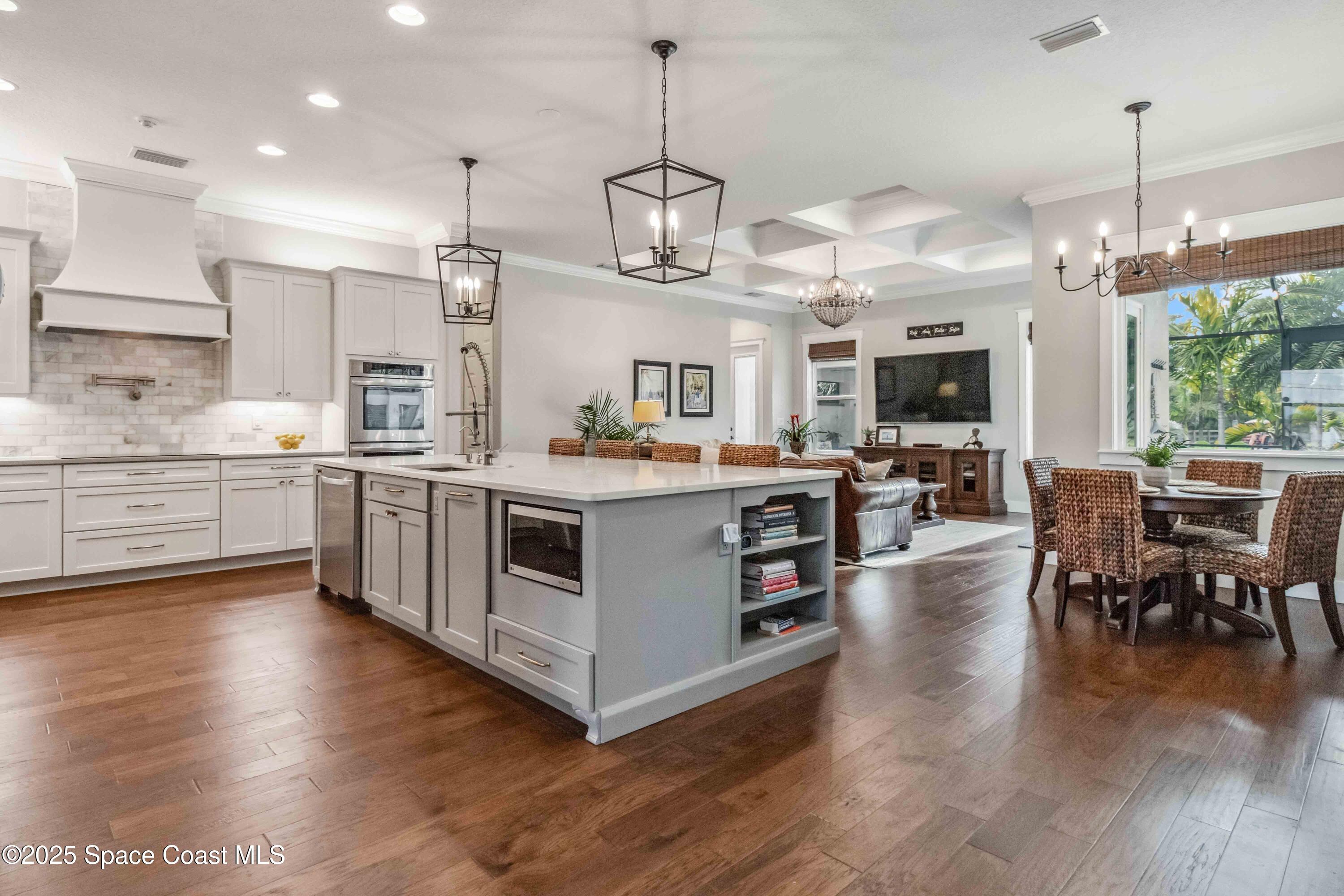 4620 Highway 1 Grant, FL 32949 - Photo 4 of 65 a kitchen with stainless steel appliances granite countertop wooden floors and white cabinets