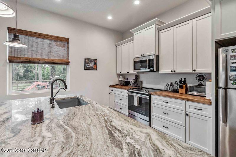 4620 Highway 1 Grant, FL 32949 - Photo 60 of 65 a kitchen with granite countertop a stove and a sink