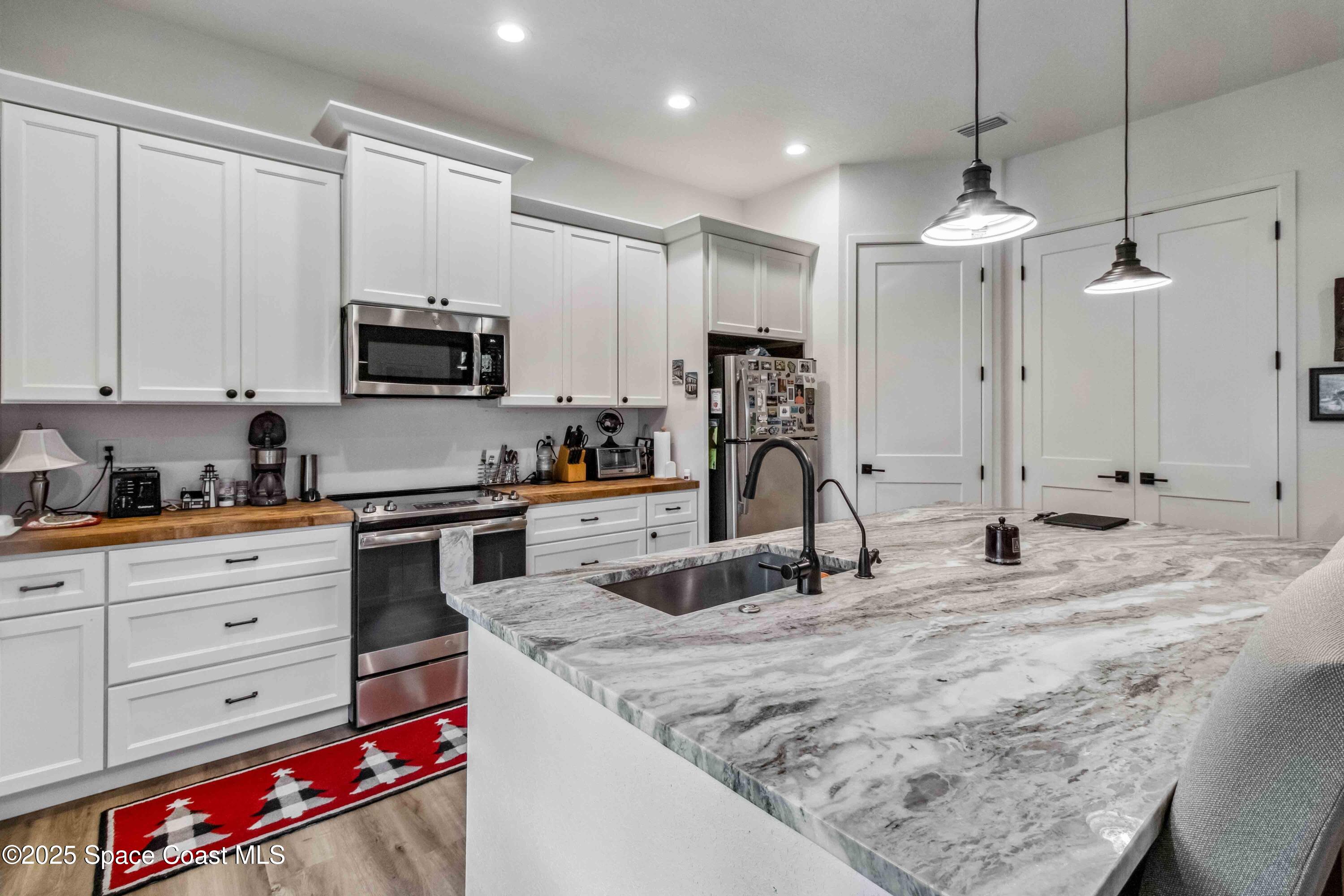 4620 Highway 1 Grant, FL 32949 - Photo 64 of 65 a kitchen with kitchen island granite countertop a sink stainless steel appliances and cabinets