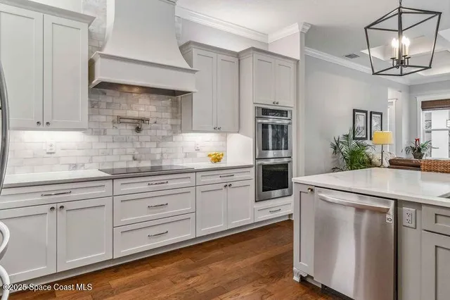 a living room with furniture a flat screen tv and a floor to ceiling window