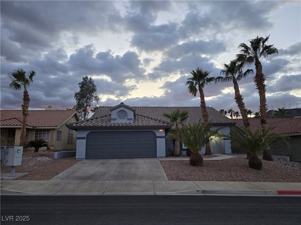 853 Rusty Anchor Way Henderson, NV 89002 - Photo 59 of 76 View of front of home with a tiled roof, concrete driveway, stucco siding, and an attached garage