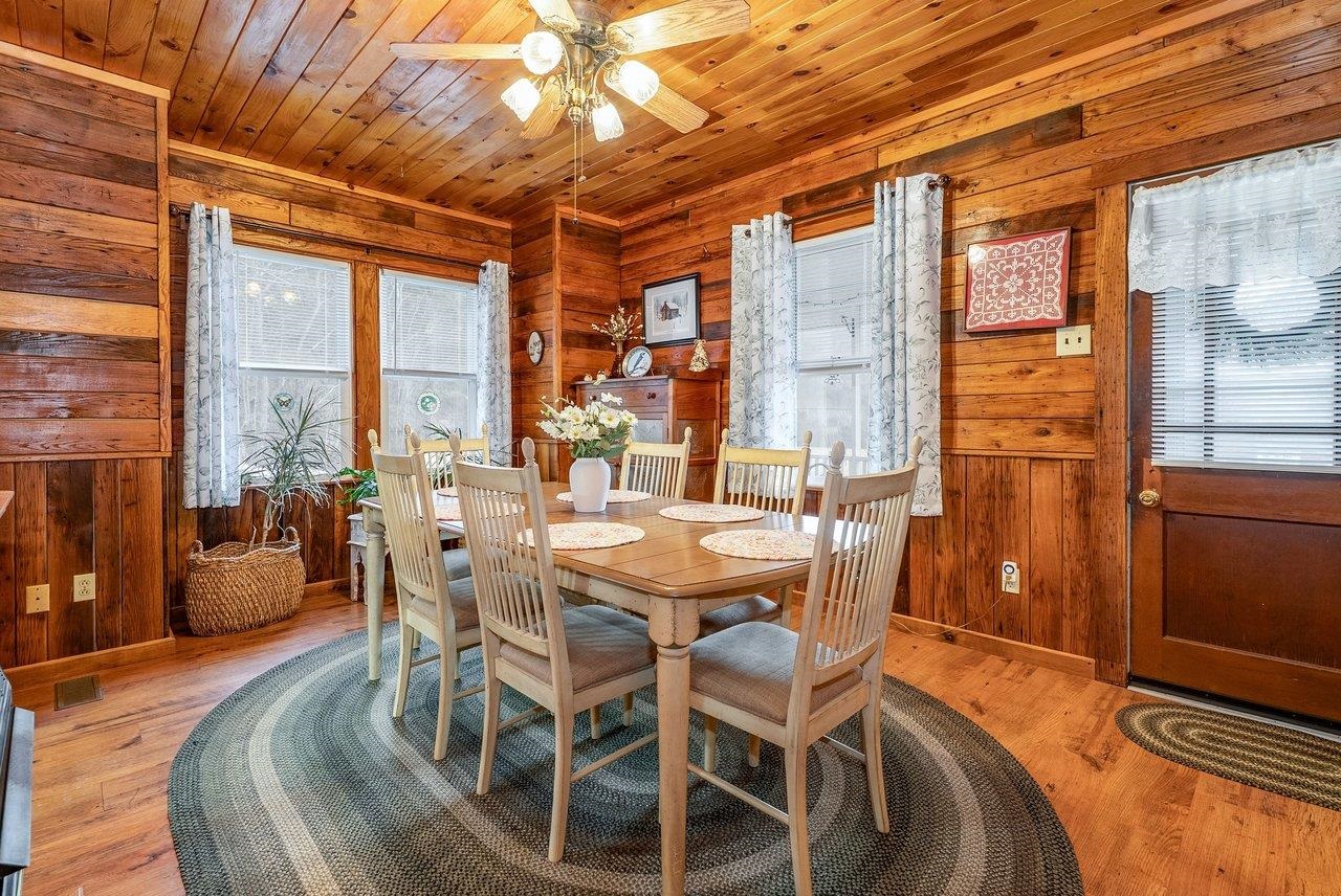 8545 Sugar Grove Road Sugar Grove, WV 26815 - Photo 20 of 75 a dining room with furniture a chandelier and wooden floor
