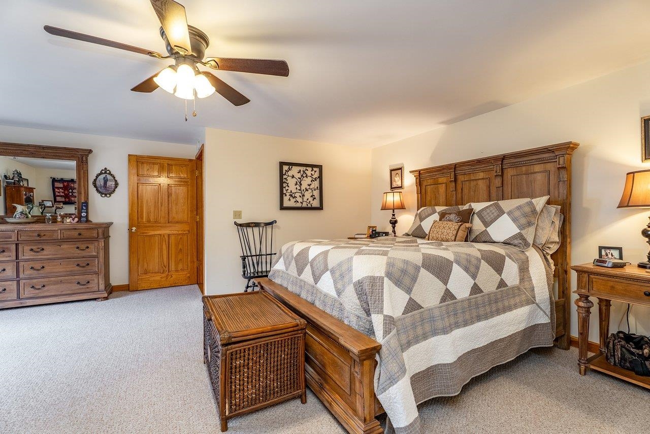 8545 Sugar Grove Road Sugar Grove, WV 26815 - Photo 25 of 75 a bed room with a bed and a chandelier