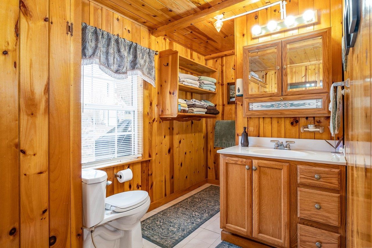 8545 Sugar Grove Road Sugar Grove, WV 26815 - Photo 32 of 75 a bathroom with a granite countertop sink and a shower