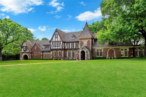 a view of a house with a big yard and large trees