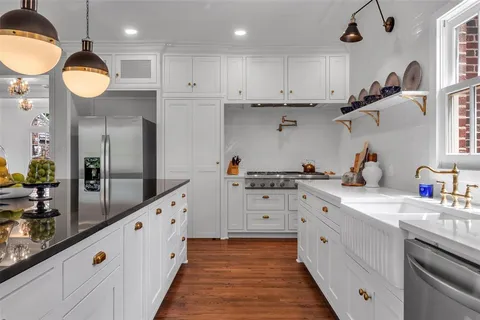 a kitchen with cabinets a sink and appliances