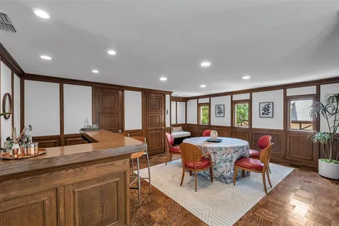 a view of a a dining room with furniture window and wooden floor
