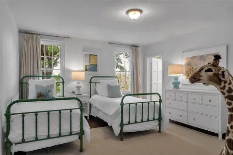 a bedroom with furniture and a window