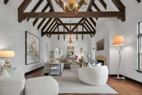 a living room with furniture and a wall painting