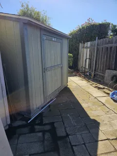 a view of a backyard with wooden fence
