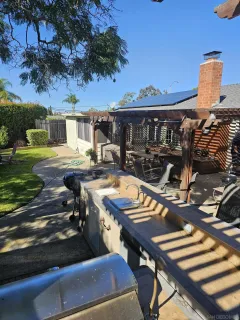 a view of a patio with table and chairs with wooden floor and fence