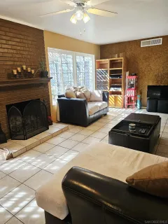 a bedroom with a bed dresser and a fireplace