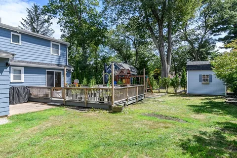 a view of a house with a yard and sitting area