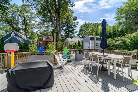 a view of a patio with couches table and chairs and wooden floor
