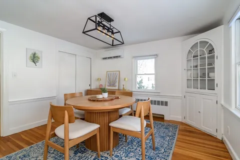 a view of a dining room with furniture window and wooden floor