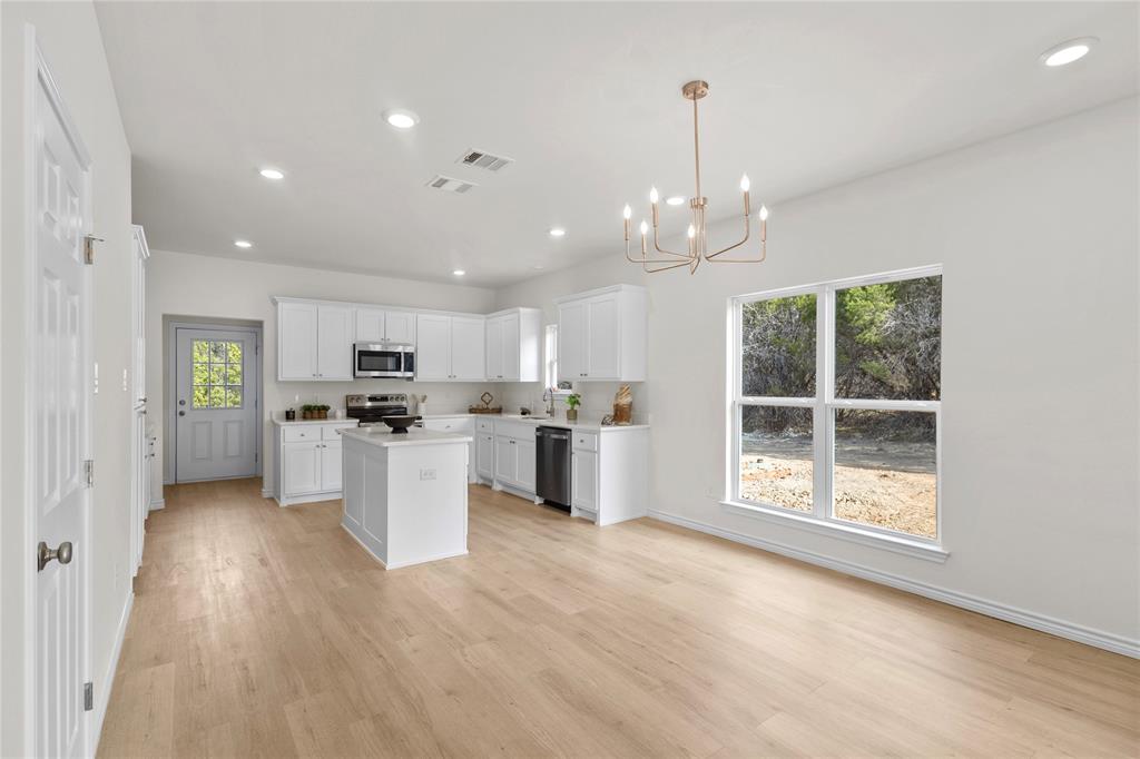 123 Cedar Shadow Lane Whitney, TX 76692 - Photo 9 of 27 a kitchen with white cabinets and window