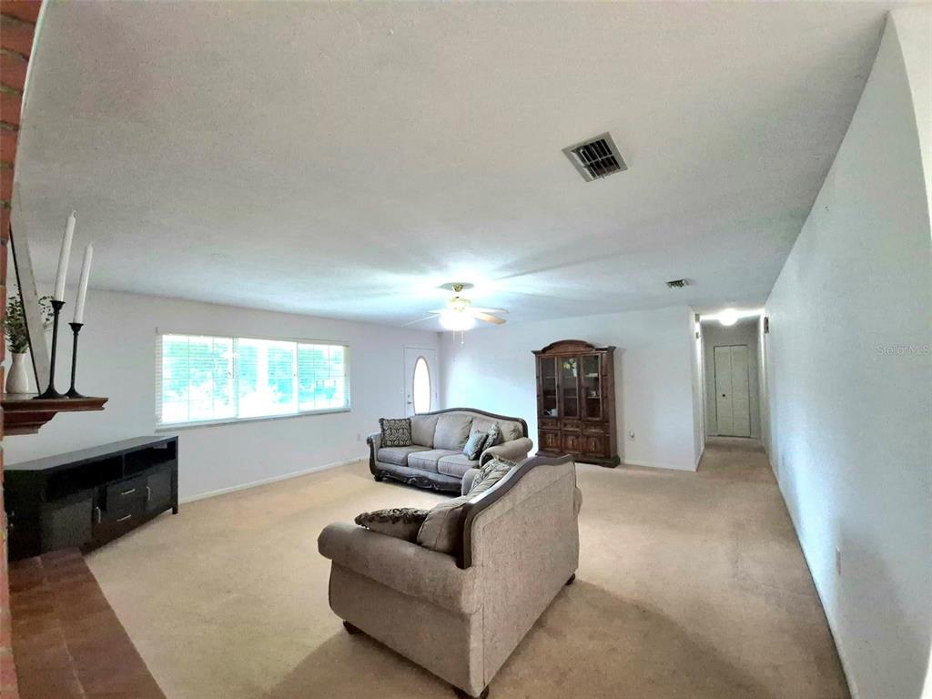 25632 Southwest 19 Avenue Newberry, FL 32669 - Photo 4 of 20 a living room with furniture and a large window
