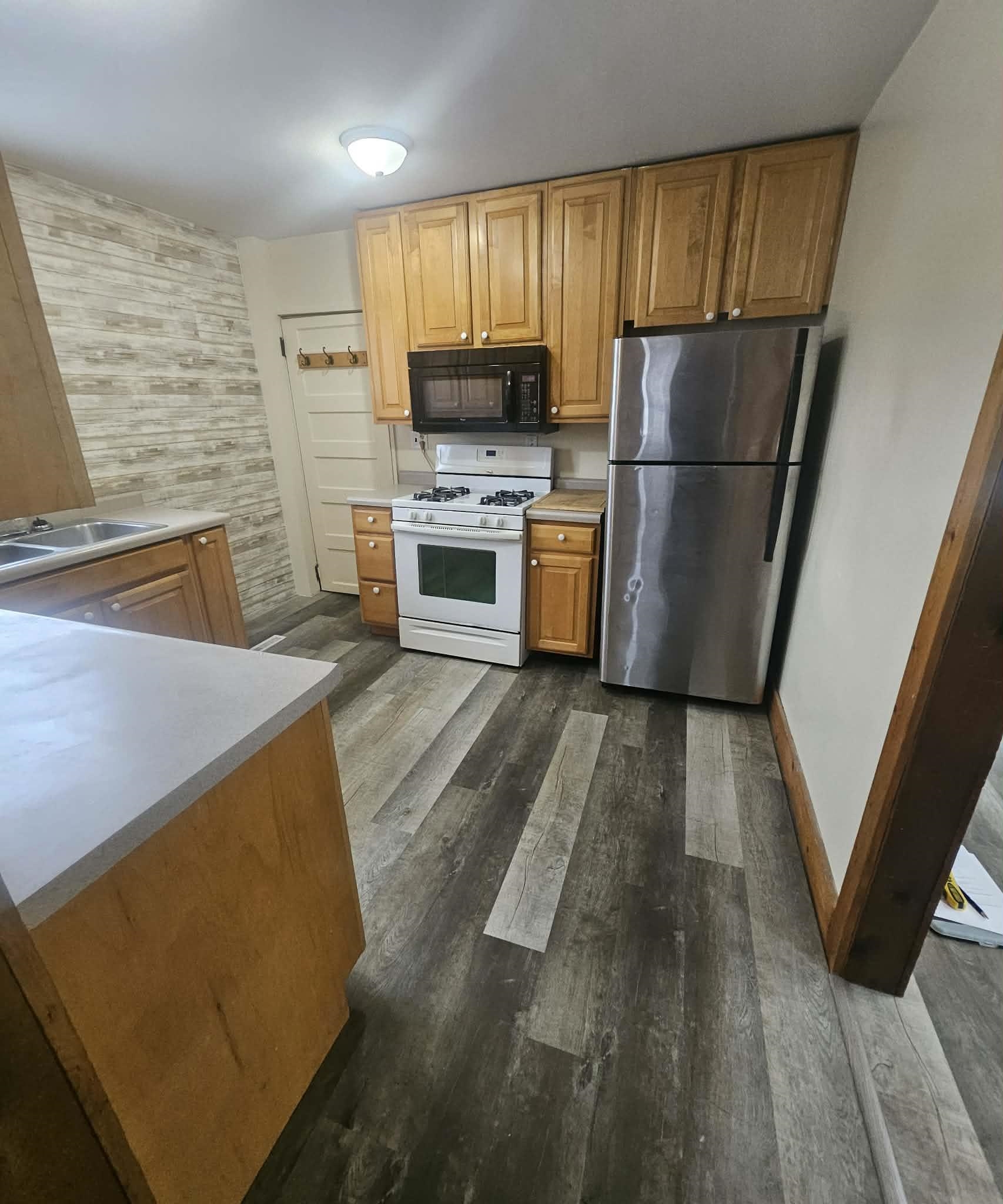 110 South 8th Street Beloit, WI 53511 - Photo 4 of 19 a kitchen with a refrigerator a stove top oven a sink and dishwasher