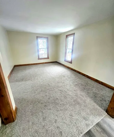 a bathroom with a sink a toilet and a window