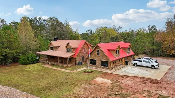 an aerial view of a house with swimming pool and garden