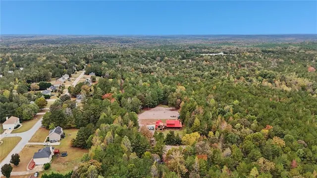 a view of a city and an aerial view of a houses with a yard