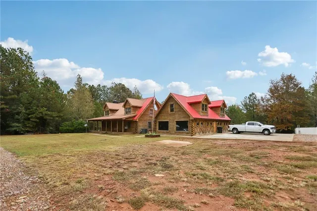 a view of a house with swimming pool and sitting area