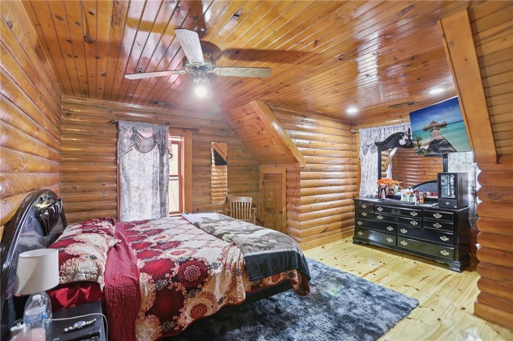 5467 Highway 162 Covington, GA 30016 - Photo 43 of 53 a bedroom with a bed and dresser with mirror