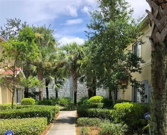 a front view of a house with plants and trees