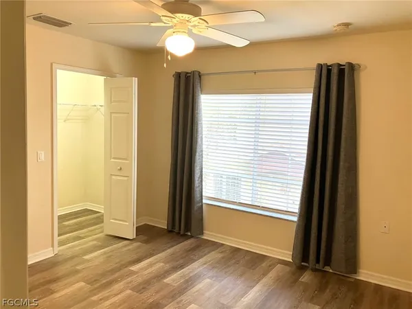 a view of a room with wooden floor and a window