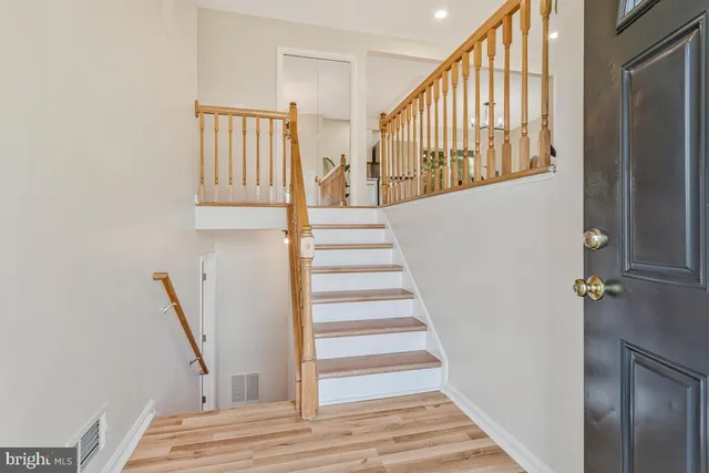 a kitchen with cabinets stainless steel appliances and a window