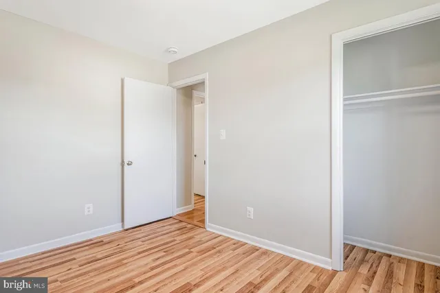 a living room with furniture a fireplace and a table with wooden floor