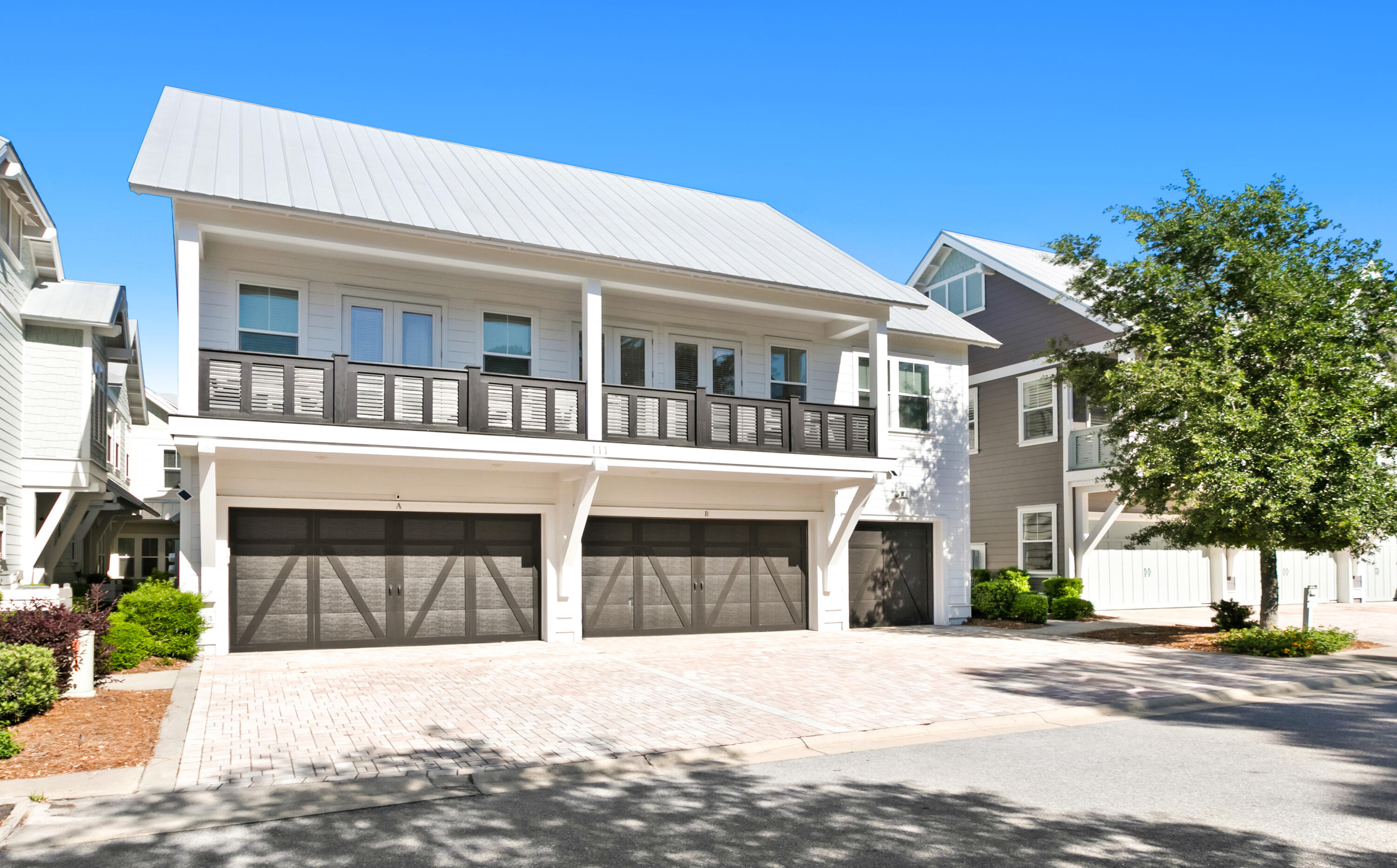 111 East Milestone Drive, Unit C Inlet Beach, FL 32461 - Photo 1 of 37 a front view of a building with a garden and entryway