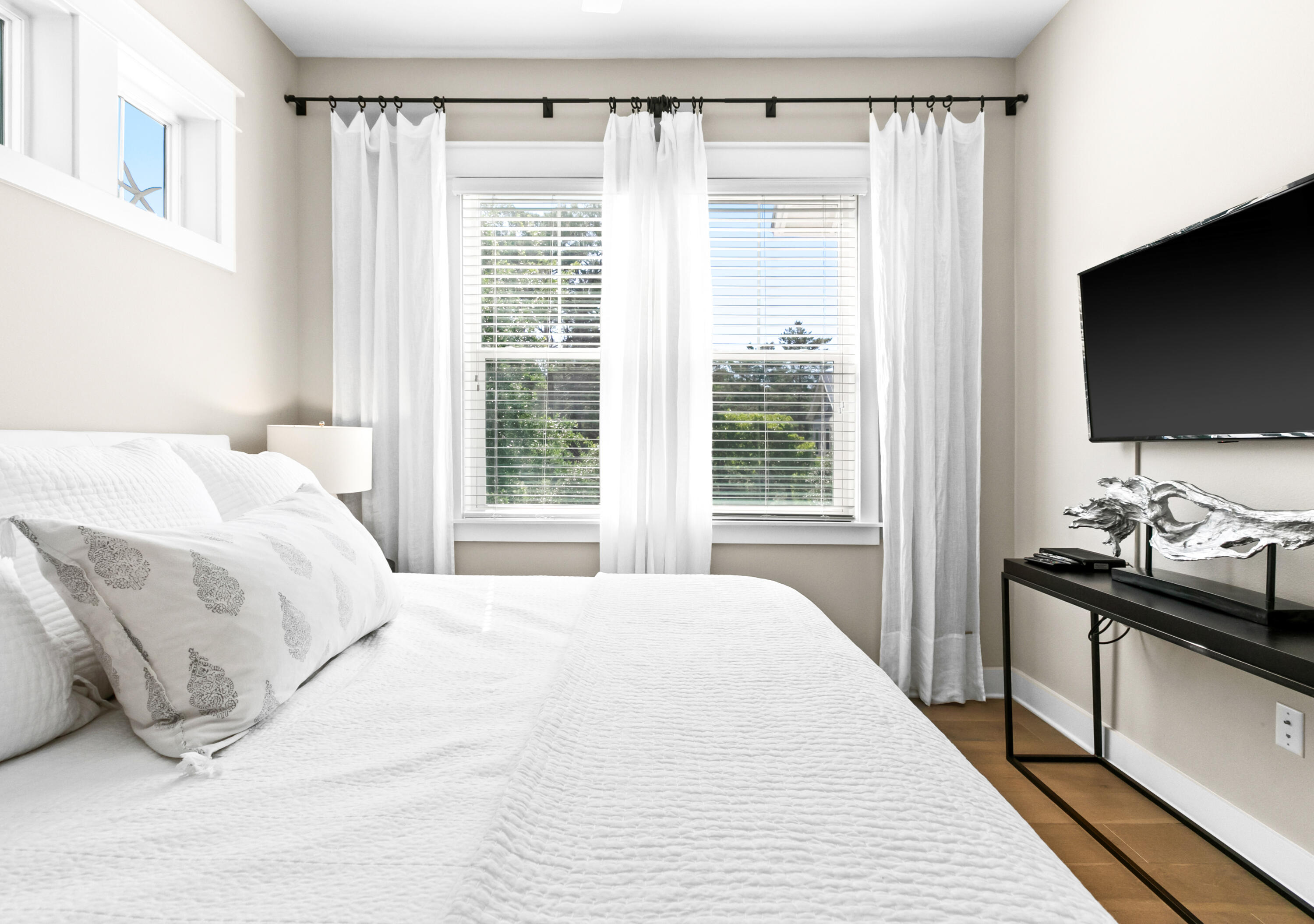 111 East Milestone Drive, Unit C Inlet Beach, FL 32461 - Photo 15 of 37 a bedroom with a bed and a flat tv screen on dresser