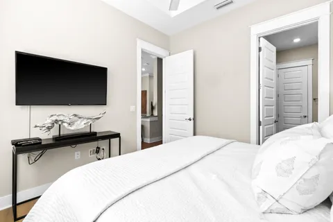 a bedroom with a bed and a flat screen tv