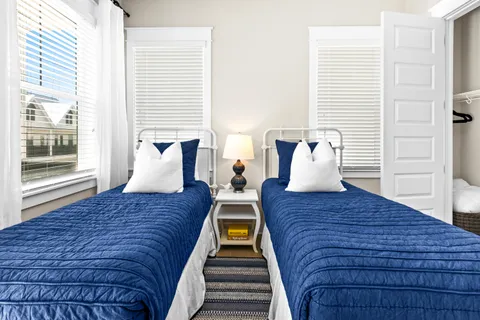 a bed sitting in a bedroom next to a window