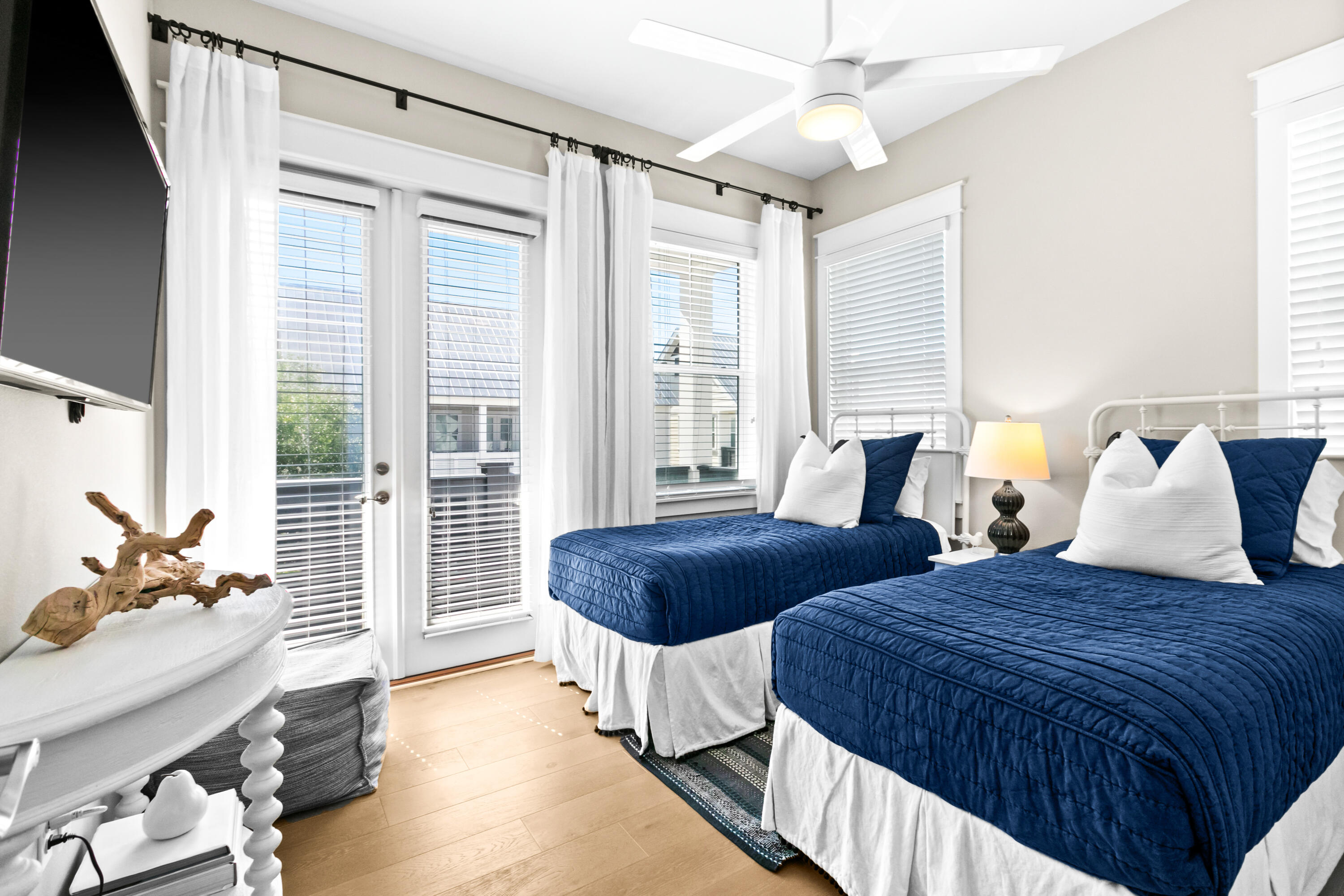 111 East Milestone Drive, Unit C Inlet Beach, FL 32461 - Photo 25 of 37 a bedroom with two beds and a chandelier